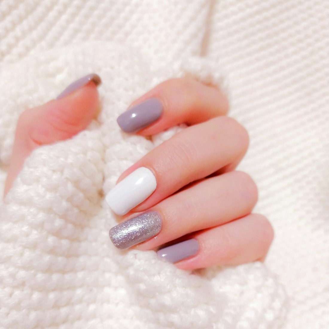 Detailed nail art in a modern neutral style
